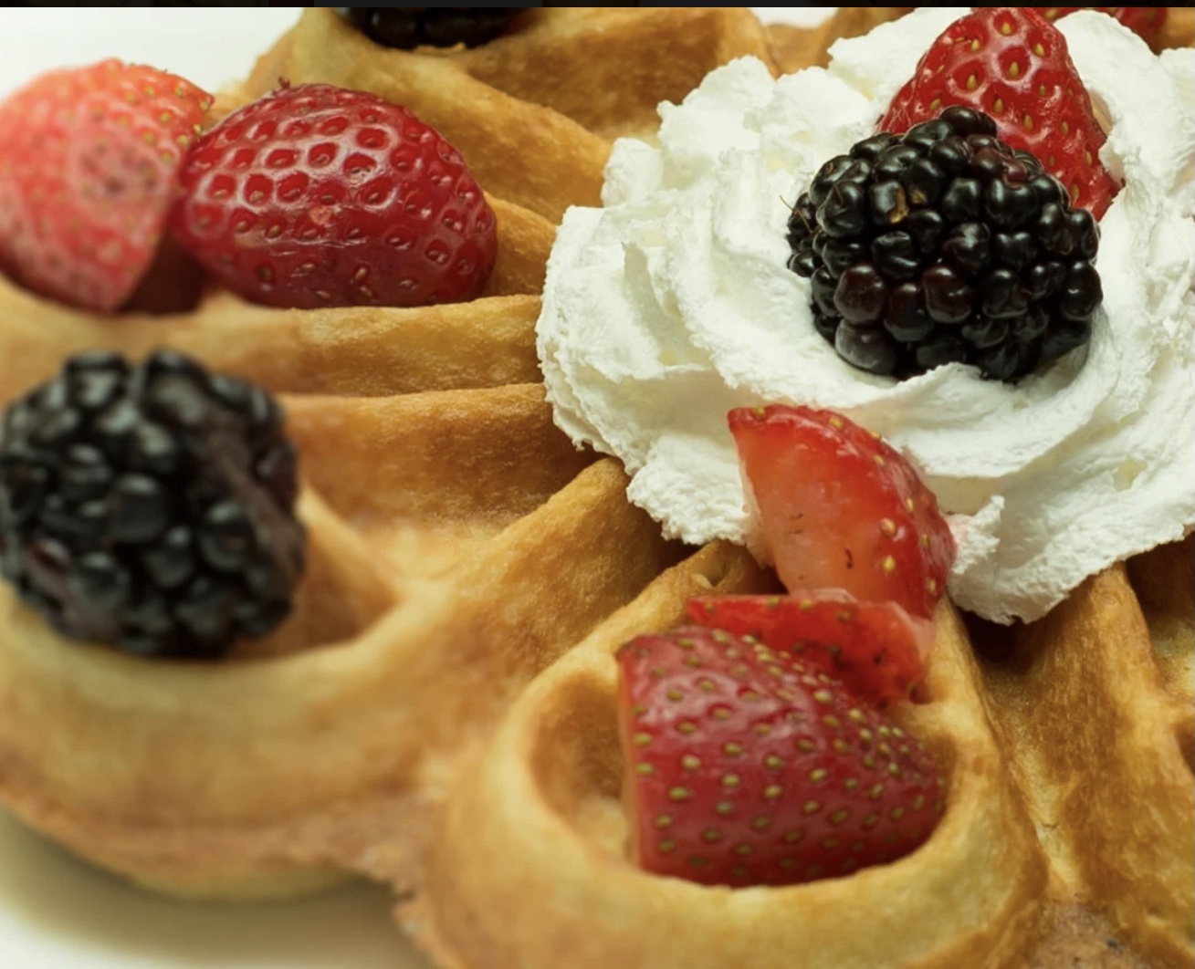 Belgian waffle with fresh berries and whipped cream
